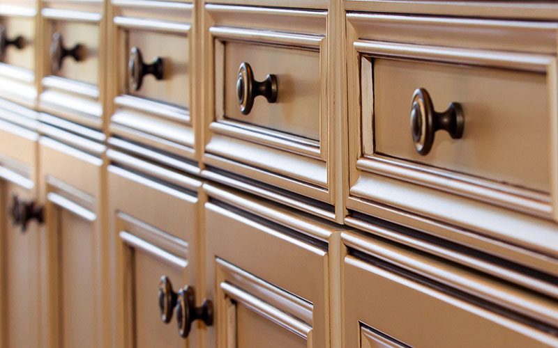 A close up of the handles on a cabinet