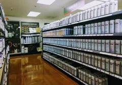 A store filled with lots of shelves full of paint.