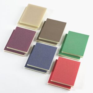 A group of six different colored notebooks on top of each other.