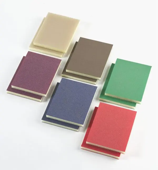 A group of six different colored notebooks on top of each other.