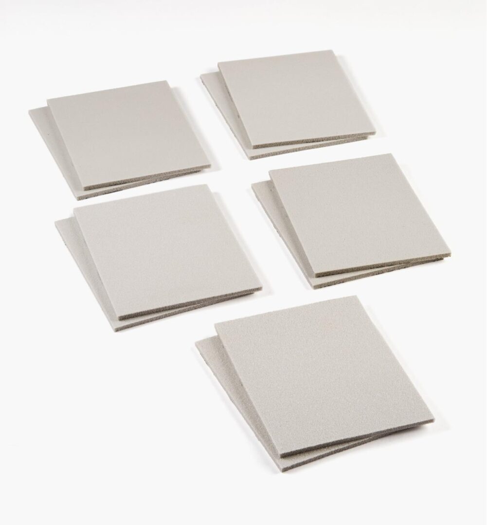A set of five square shaped paper napkins.