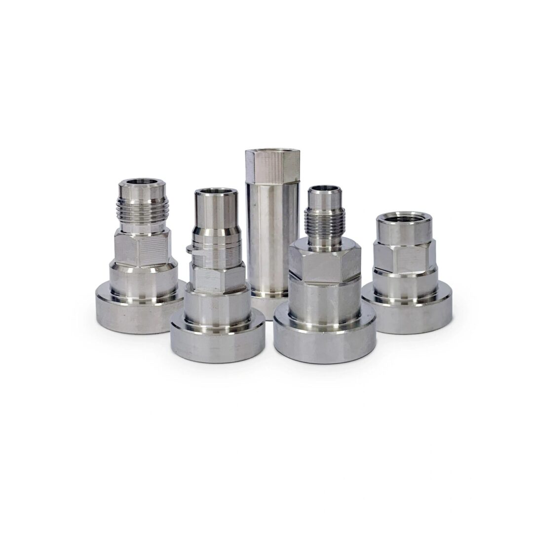 A group of stainless steel couplings sitting on top of each other.
