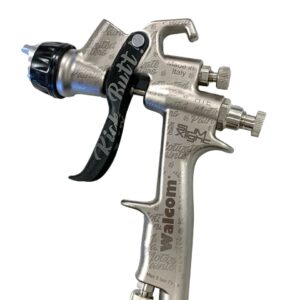 A spray gun with the handle extended and the nozzle attached.